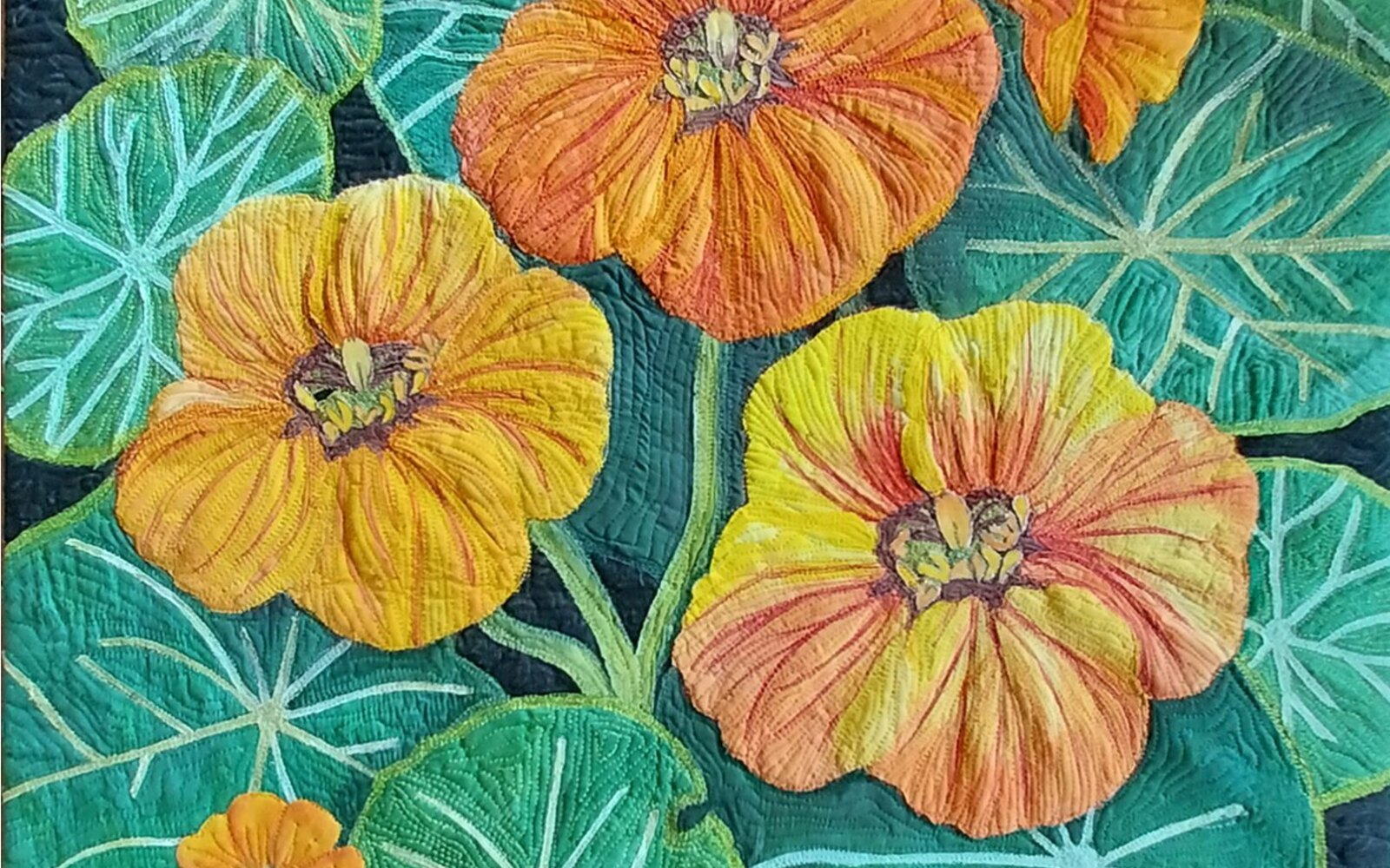 Nasturtiums thread painted and quilted in bright orange and yellow