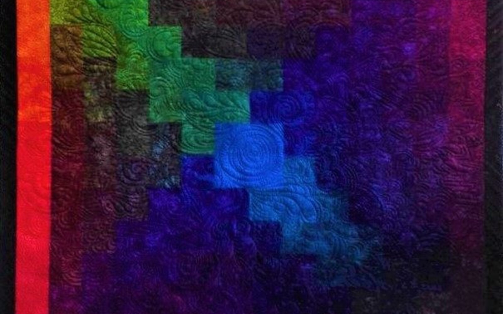 Rainbow log cabin quilt in rich dyed colour
